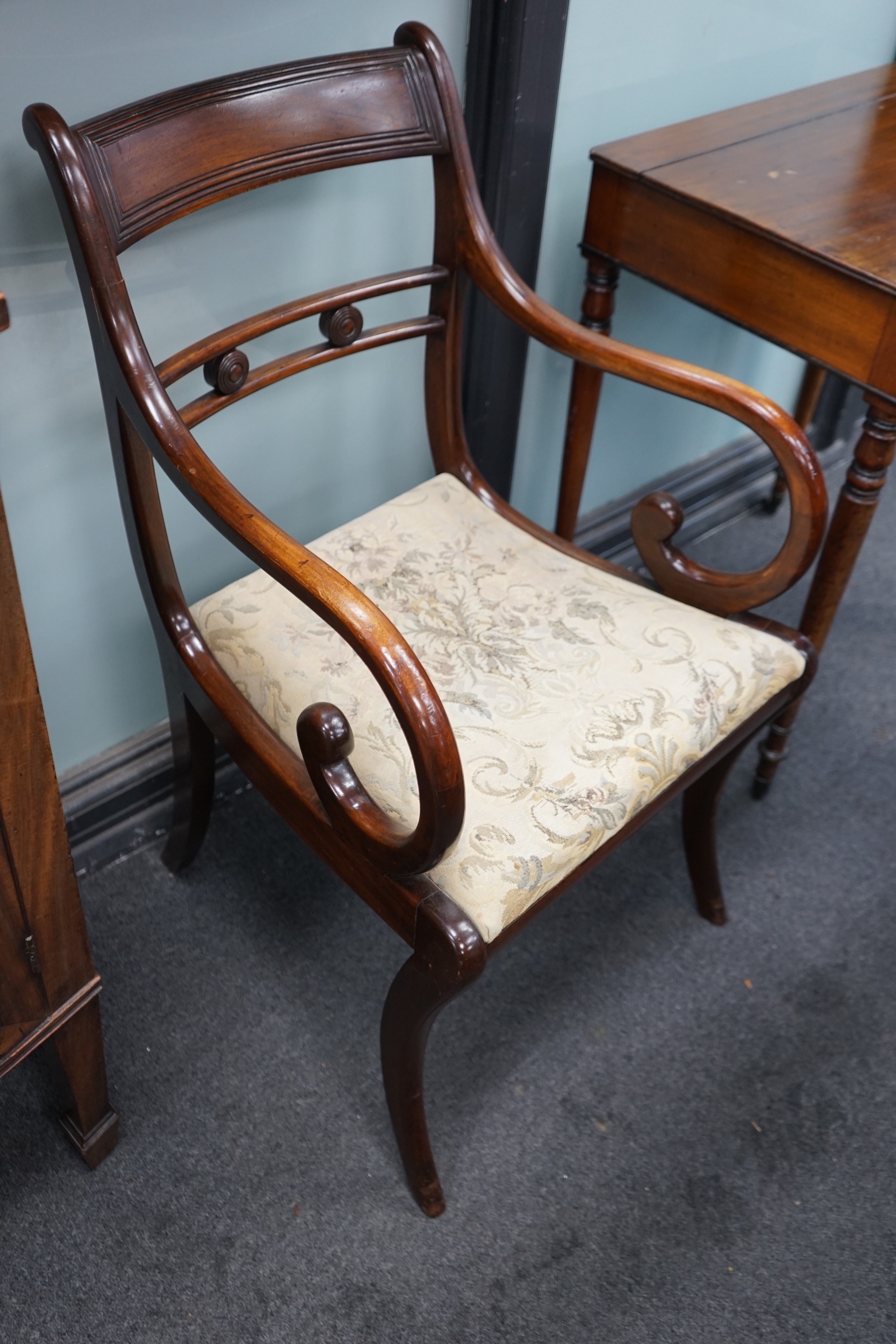 A harlequin set of eight Regency and later mahogany dining chairs on sabre legs, two with arms